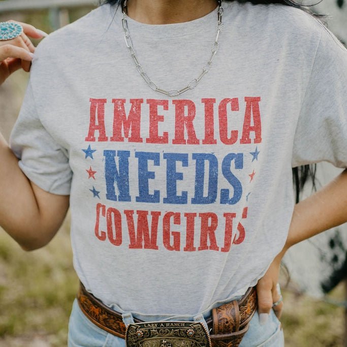 America Needs Cowgirls TeeWhiteS